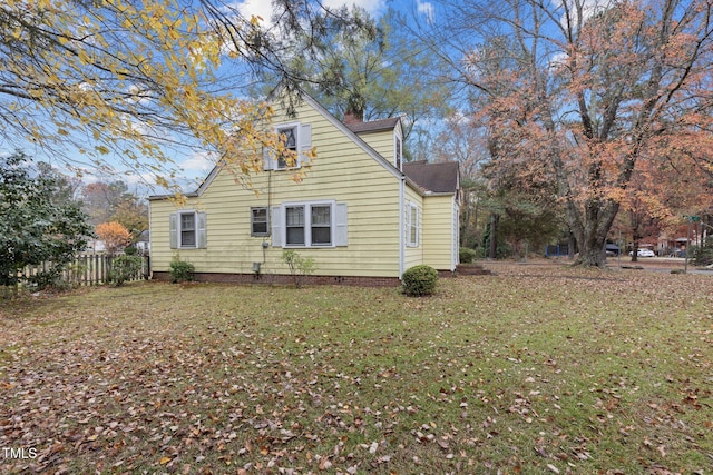 view of side of home featuring a yard