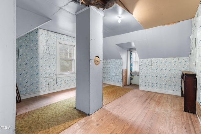 bonus room featuring wood-type flooring, a wealth of natural light, and lofted ceiling