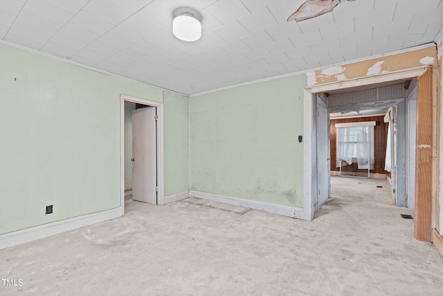 carpeted empty room with crown molding