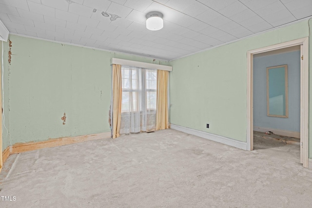 unfurnished room featuring light carpet and crown molding