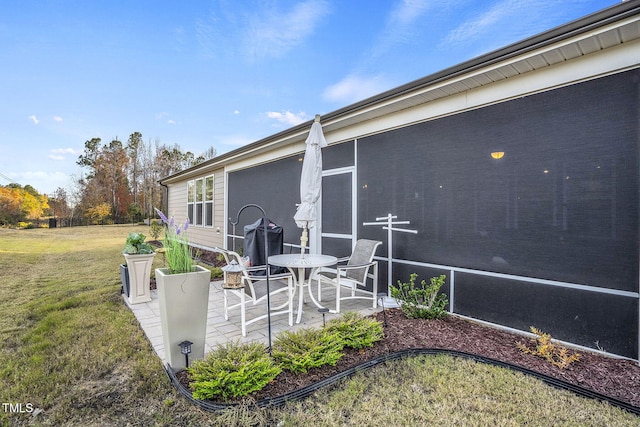 view of patio / terrace featuring a sunroom