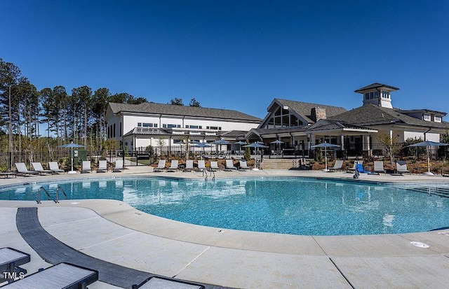 pool featuring a patio and fence