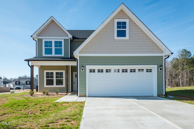 view of front of property featuring a front lawn, concrete driveway, and an attached garage