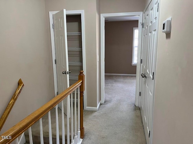 hall featuring light colored carpet