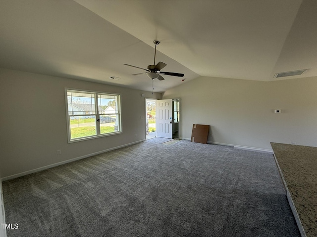 empty room with visible vents, a ceiling fan, lofted ceiling, and carpet floors