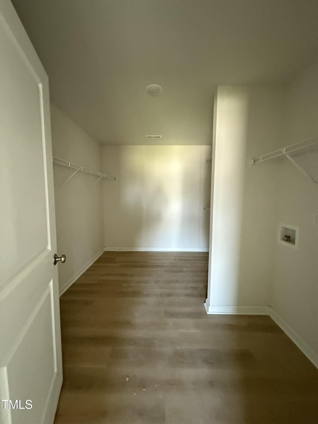 walk in closet with wood finished floors and visible vents