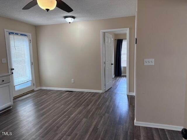 spare room featuring a textured ceiling, dark hardwood / wood-style floors, and ceiling fan