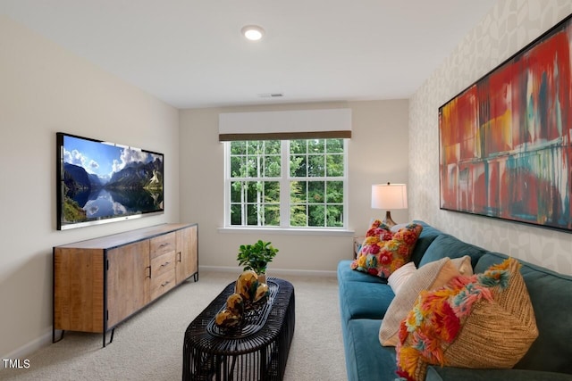 living room with baseboards and light colored carpet