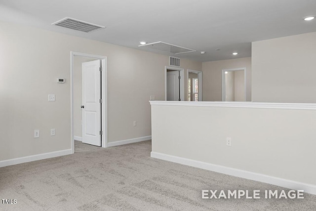 unfurnished room featuring light colored carpet