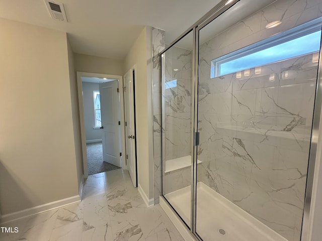 bathroom featuring a shower with shower door