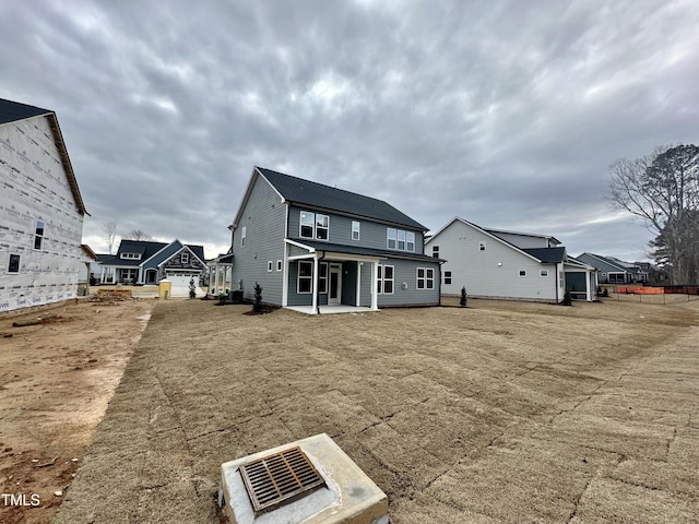 rear view of house featuring a garage and a patio