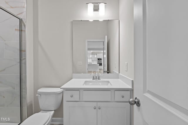 full bathroom featuring a shower with shower door, vanity, and toilet