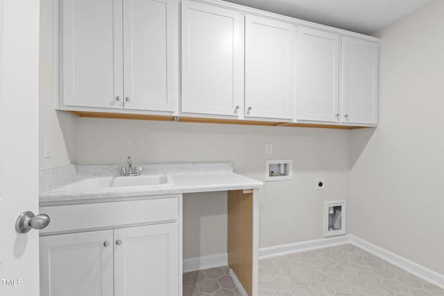 washroom with washer hookup, cabinet space, a sink, electric dryer hookup, and baseboards