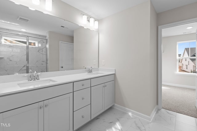 bathroom featuring marble finish floor, visible vents, and a sink