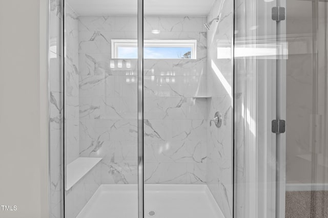 full bath featuring a marble finish shower