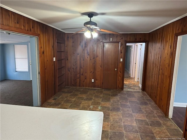 hall with wood walls and crown molding