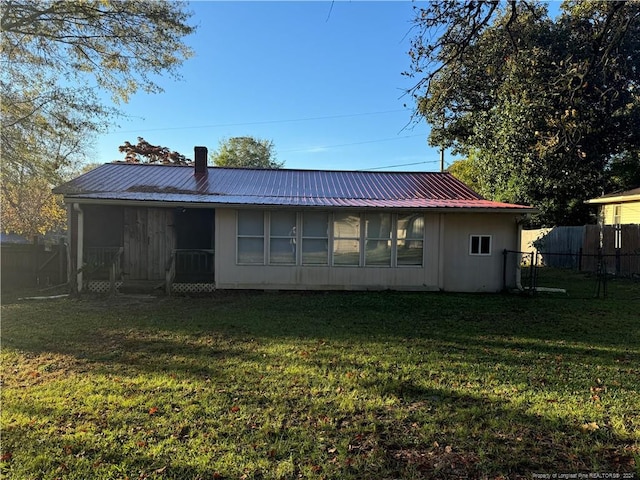 rear view of house with a lawn