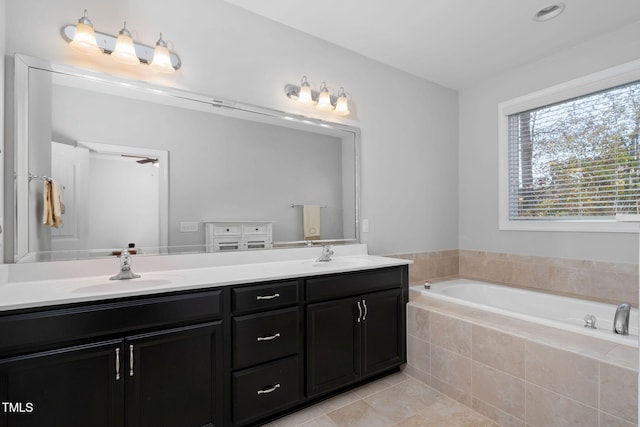 bathroom with tiled bath, tile patterned floors, and vanity