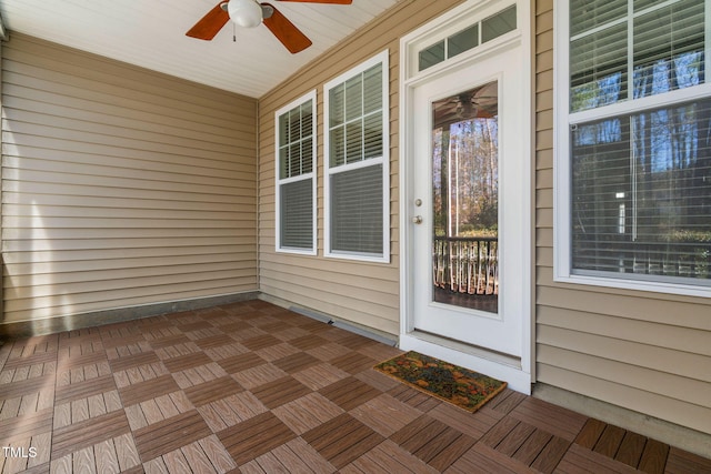 doorway to property featuring ceiling fan and covered porch