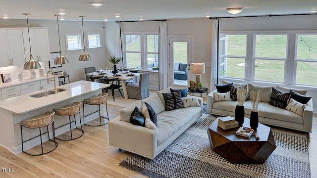 living room with sink and light hardwood / wood-style floors