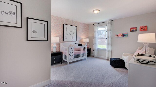 bedroom with carpet floors and a nursery area