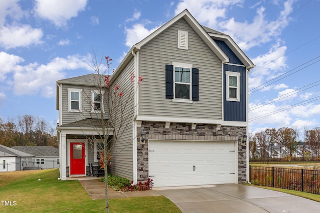 view of front of property featuring a front yard and a garage