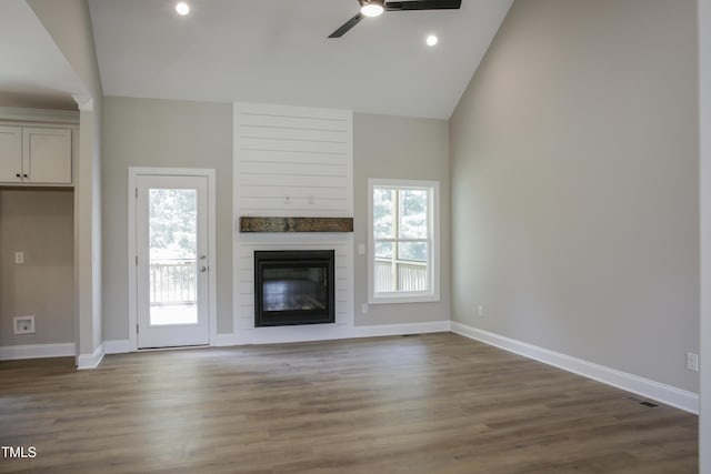 unfurnished living room with ceiling fan, dark wood-type flooring, and high vaulted ceiling