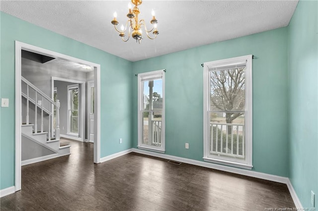 310 Interchange Dr, Fayetteville, NC 28311 - spare room with a textured ceiling, dark wood-type flooring, and a healthy amount of sunlight