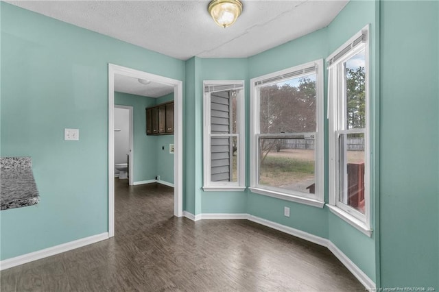 310 Interchange Dr, Fayetteville, NC 28311 - spare room with dark hardwood / wood-style flooring and a textured ceiling