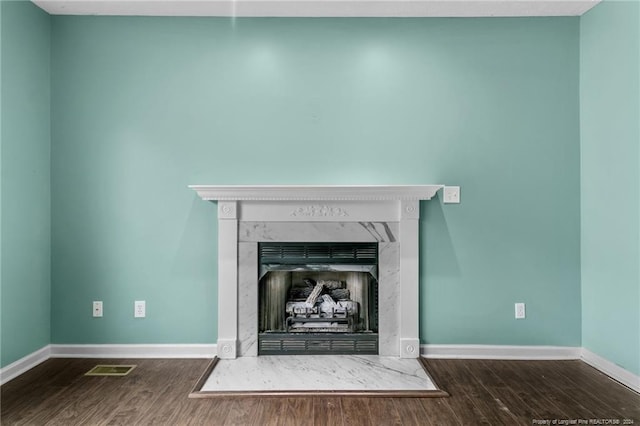 310 Interchange Dr, Fayetteville, NC 28311 - details featuring wood-type flooring and a premium fireplace