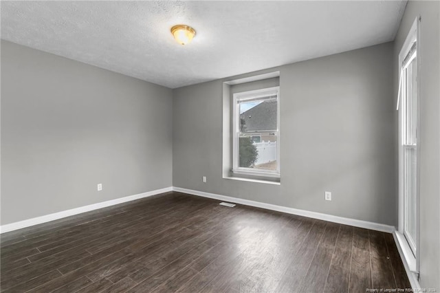 310 Interchange Dr, Fayetteville, NC 28311 - unfurnished room with dark hardwood / wood-style flooring and a textured ceiling