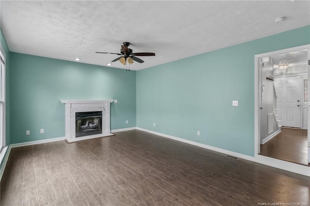 310 Interchange Dr, Fayetteville, NC 28311 - unfurnished living room with ceiling fan, dark hardwood / wood-style flooring, and a textured ceiling