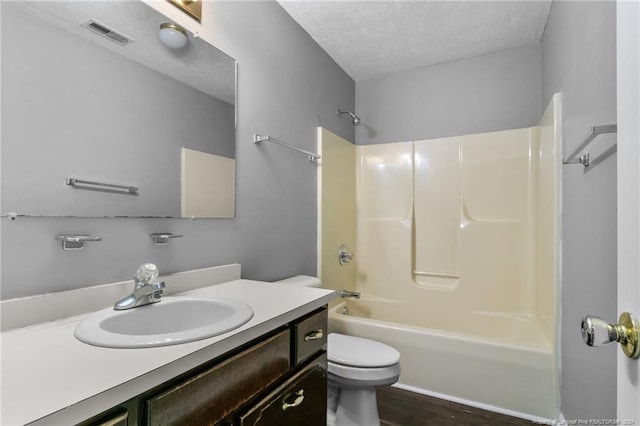 310 Interchange Dr, Fayetteville, NC 28311 - full bathroom with hardwood / wood-style floors,  shower combination, a textured ceiling, toilet, and vanity
