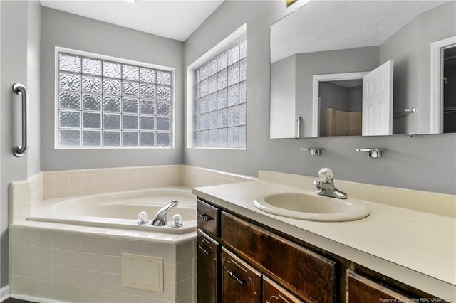 310 Interchange Dr, Fayetteville, NC 28311 - bathroom with vanity and a relaxing tiled tub