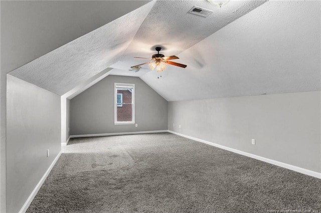 310 Interchange Dr, Fayetteville, NC 28311 - additional living space featuring a textured ceiling, ceiling fan, carpet floors, and lofted ceiling