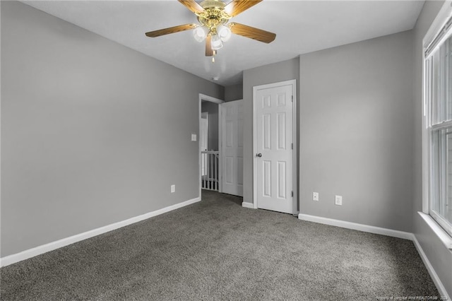 310 Interchange Dr, Fayetteville, NC 28311 - unfurnished bedroom with carpet, multiple windows, and ceiling fan