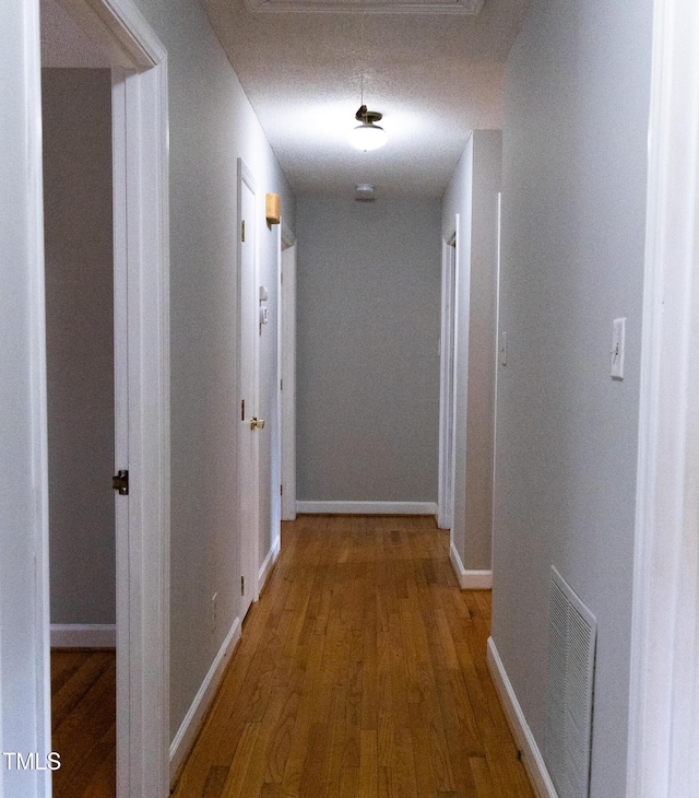 hall with hardwood / wood-style floors