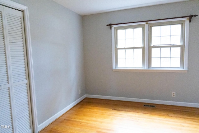 unfurnished bedroom featuring a closet and light hardwood / wood-style floors