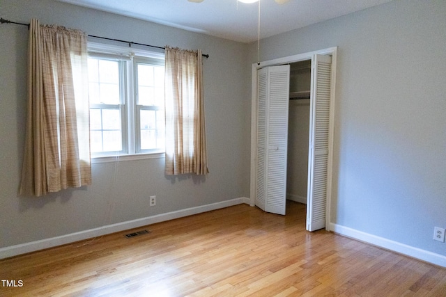 unfurnished bedroom featuring hardwood / wood-style flooring and a closet