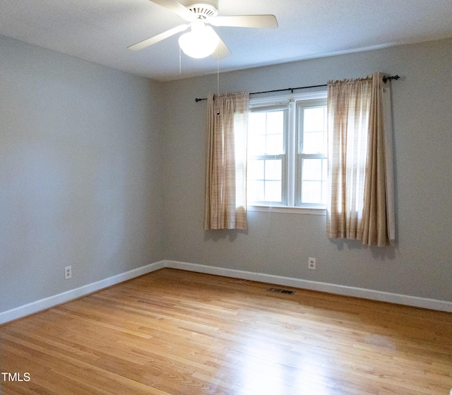 spare room with light hardwood / wood-style flooring and ceiling fan