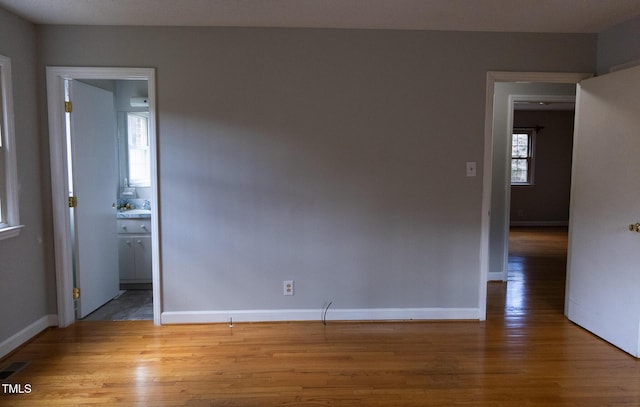 unfurnished room with hardwood / wood-style floors