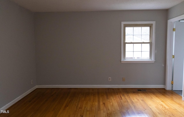 empty room with hardwood / wood-style floors