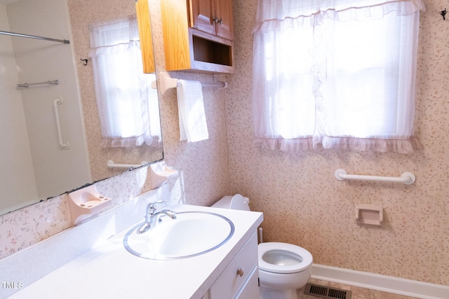 bathroom with vanity and toilet