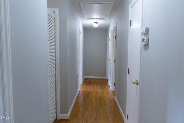 hall featuring crown molding and light hardwood / wood-style floors