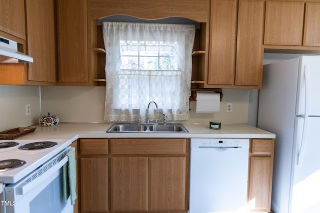 kitchen featuring white appliances, sink, and exhaust hood