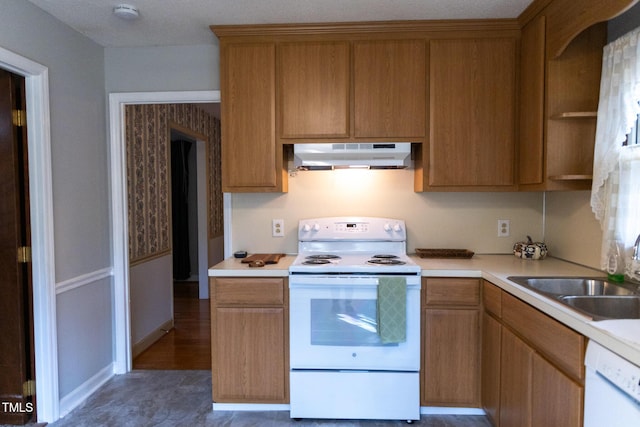 kitchen with a textured ceiling, dark hardwood / wood-style floors, white appliances, and sink