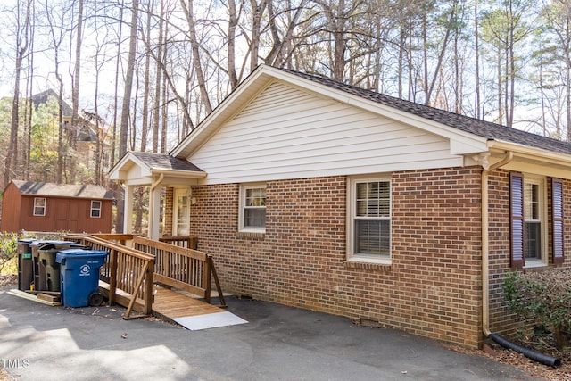 view of front of home featuring a storage unit