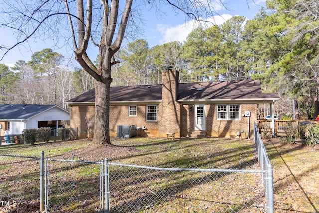 ranch-style house with a front lawn and central AC unit