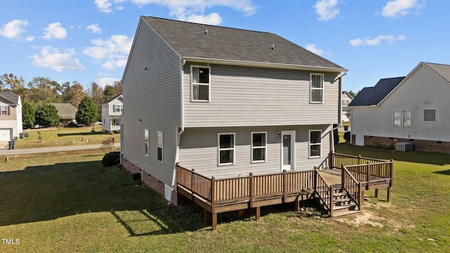 rear view of house with a yard, a deck, and cooling unit