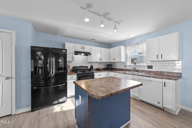 kitchen with black appliances, white cabinets, sink, light hardwood / wood-style floors, and a kitchen island